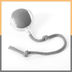 Gray silicone cat ball toy with a rope on a white background