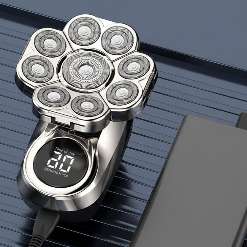 Silver electric razor with digital display on a dark background